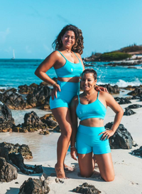 2 models in Boca Catalina Blue Sports Bra and Shorts on Boca Catalina Beach in Aruba